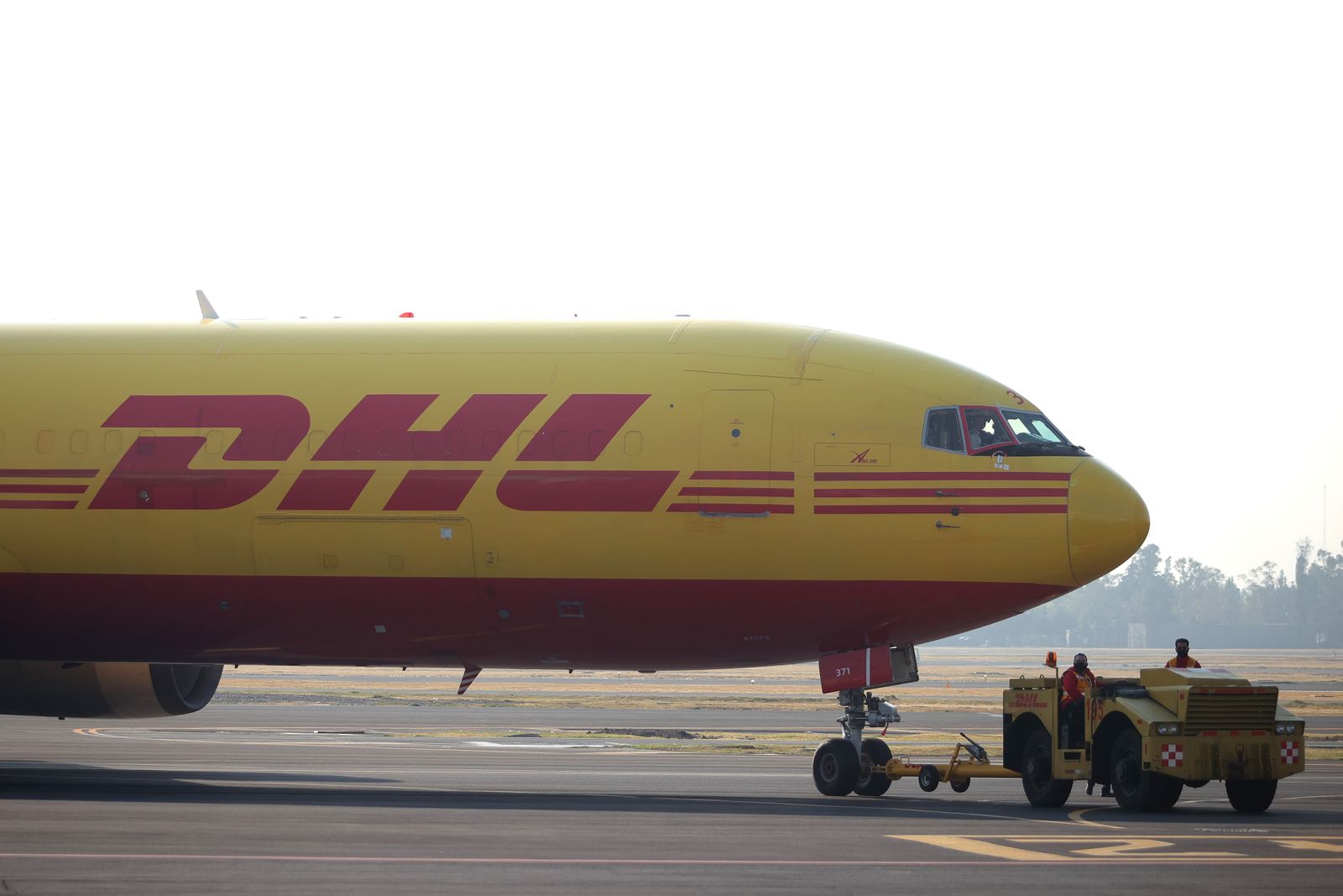 A DHL airplane is pulled at Benito Juarez International Airport on December 23, 2020 in Mexico City, Mexico.