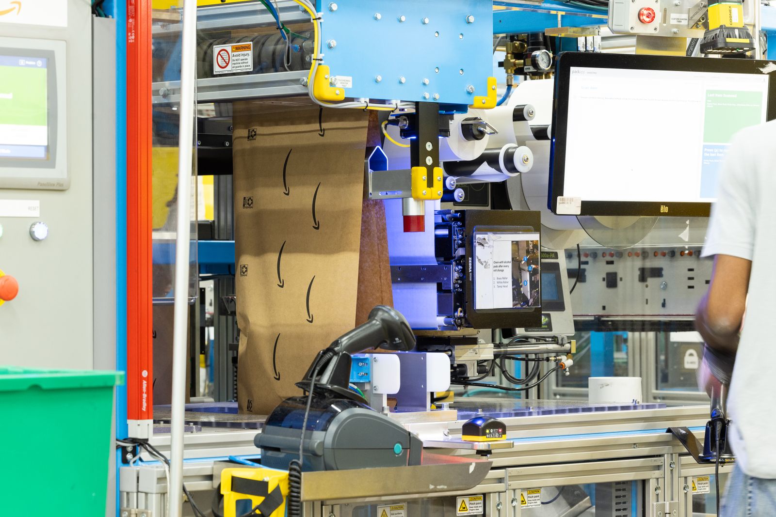 Amazon-branded packaging on equipment at a shipping fulfillment center.