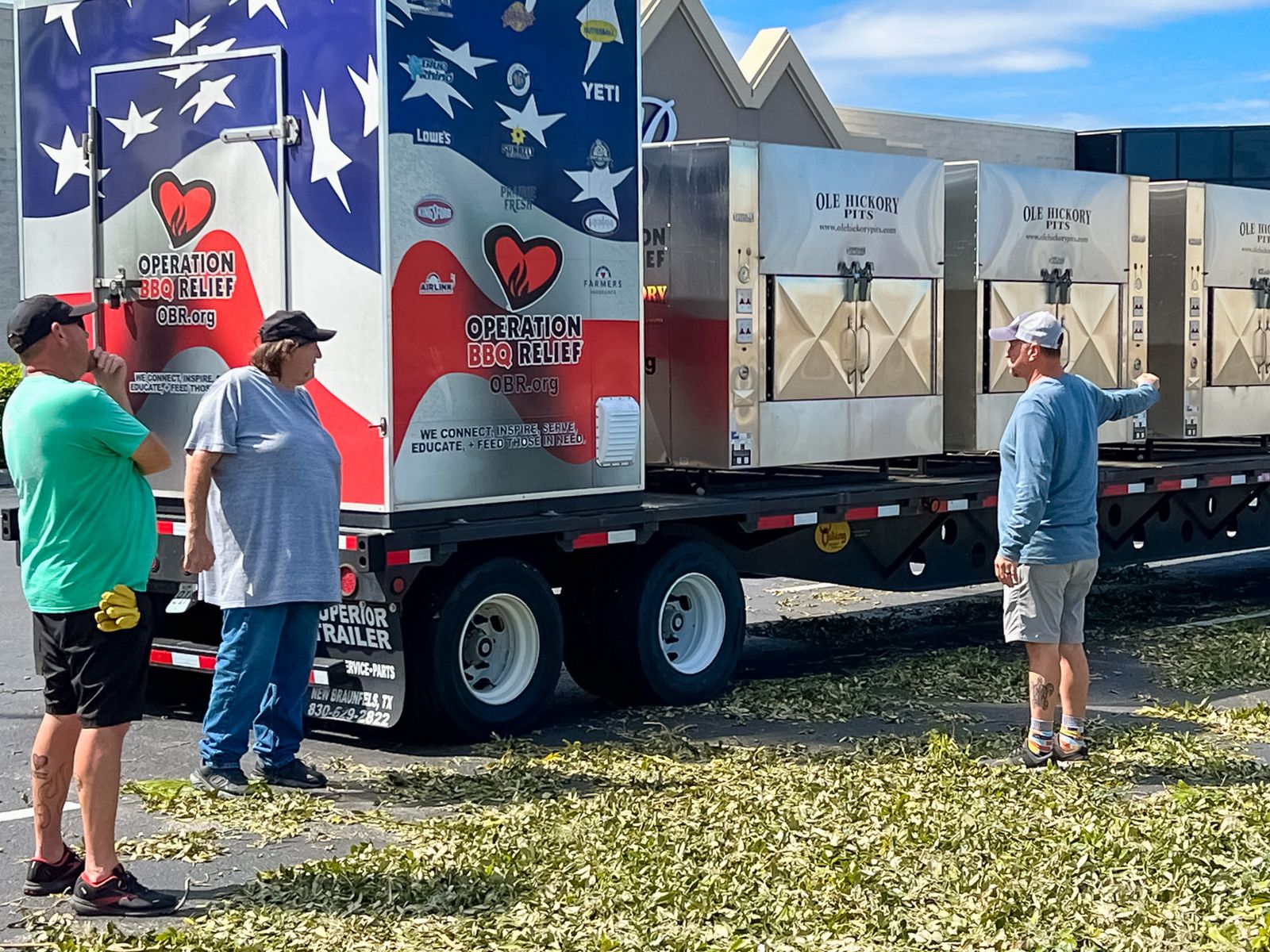 Joe Myerly, in a gray T-shirt on the left, brought five giant meat smokers on a flatbed to the Operation BBQ Relief meal distribution site in Charlotte County, Florida, following Hurricane Ian.